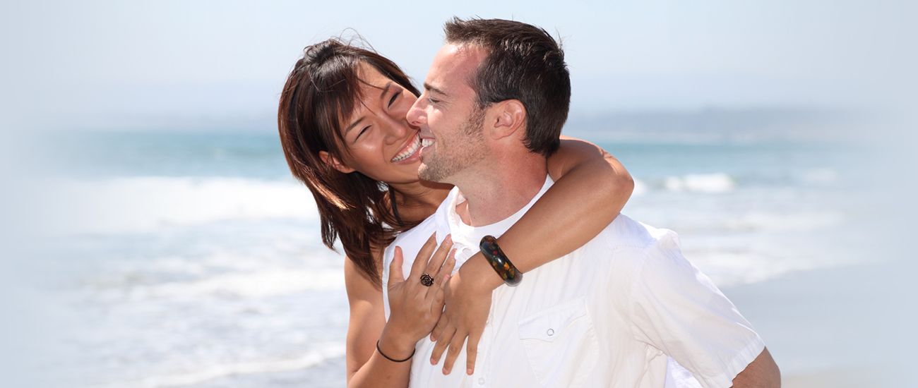 A couple shares a heartfelt hug on the beach